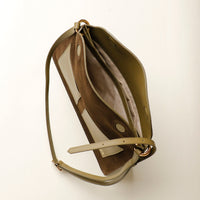 Open interior of Olive Suede Penelope Sr. bag in Brown with fold-over magnetic closure