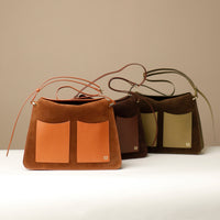 A collection of Suede Penelope Sr. bag in Brown with fold-over magnetic closure