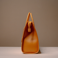 Side View of Luxury Eva Sofia Bag with leather trim, natural fiber weave, and adjustable shoulder strap