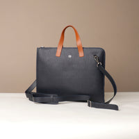 Blue leather bag with brown handle on a beige background