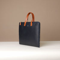 Blue leather briefcase with brown handles on a beige background