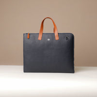 Blue leather briefcase with brown handle on a beige background