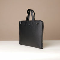 Black leather briefcase on a beige background