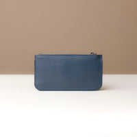 Blue leather pouch on a neutral background
