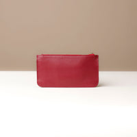 Red leather pouch on a neutral background