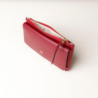 Red leather wallet with zipper on a light background