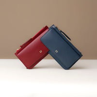 Two leather wallets, one red and one blue, on a neutral background.