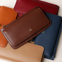 Collection of leather wallets in various colors.