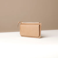 Beige wallet on a light beige background