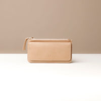 A collection of leather wallets in beige, brown, blue, and red colors, displayed stacked with the flap open on top.