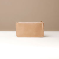 Beige leather pouch on a neutral background