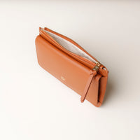 Brown leather wallet with zipper on a light background