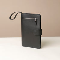 Globetrotters Document Holder black with silver hardware, with a black leather strap, ateral view