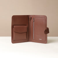 An open Globetrotters Document Holder palisander brown leather with silver hardware, with compartmetns for documents and a visible brand Danilos

