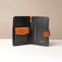 An open Globetrotters Document Holder black with brown pebble leather, with compartments for documents
