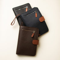 Three Globetrotters Document Holders one chocolate brown with tan, one navy blue with tan and other black with tan, made with pebble leather
