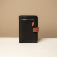 Globetrotters Document Holder black and tan pebbled leather with gold hardware, front view
