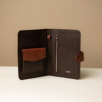 An open Globetrotters Document Holder chocolate brown pebble leather, with compartments for documents
