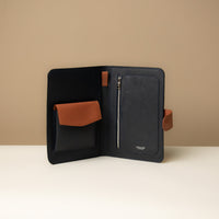 An open Globetrotters Document Holder navy blue and tan pebbled leather, with compartments for documents