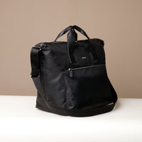 Black backpack on a beige background