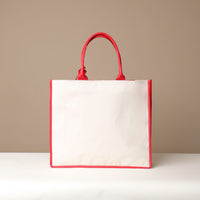 Back view of red Mercatto Tote Bag with double leather handles and woven detail