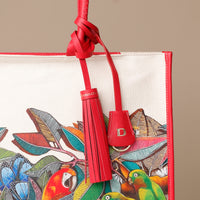 Close up view of red Mercatto Tote Bag with double leather handles and woven detail