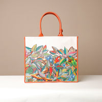 Front view of orange Mercatto Tote Bag with double leather handles and woven detail