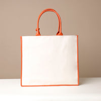Back view of orange Mercatto Tote Bag with double leather handles and woven detail