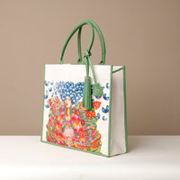 Side view of green Mercatto Tote Bag with double leather handles and woven detail