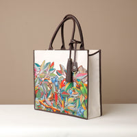 Side view of brown Mercatto Tote Bag with double leather handles and woven detail