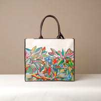 Front view of brown Mercatto Tote Bag with double leather handles and woven detail