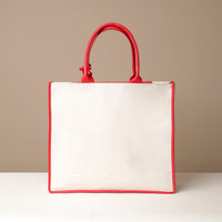 Back view of red Mercatto Tote Bag with double leather handles and woven detail