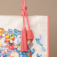 Close up view of pink Mercatto Tote Bag with double leather handles and woven detail