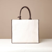 Back view of brown Mercatto Tote Bag with double leather handles and woven detail