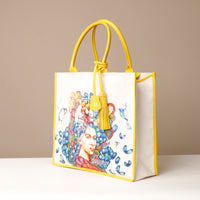 Side view of yellow Mercatto Tote Bag with double leather handles and woven detail
