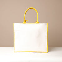 Back view of yellow Mercatto Tote Bag with double leather handles and woven detail