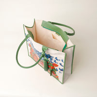 Top view of open green Mercatto Tote Bag with double leather handles and woven detail
