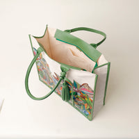 Top view of open green Mercatto Tote Bag with double leather handles and woven detail