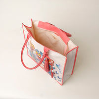 Top view of open pink Mercatto Tote Bag with double leather handles and woven detail