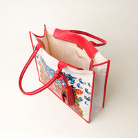 Top view of open red Mercatto Tote Bag with double leather handles and woven detail