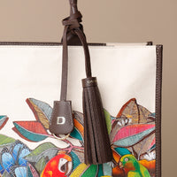 Close up view of brown Mercatto Tote Bag with double leather handles and woven detail
