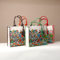 Three canvas tote bags with multicolored floral prints, displayed against a neutral background.