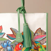 Close up view of green Mercatto Tote Bag with double leather handles and woven detail