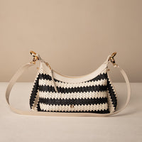 Mini Mia 26 Raffia Arena handcrafted with raffia and premium leather, with gold hardware and a leather strap, in a beige background, front view