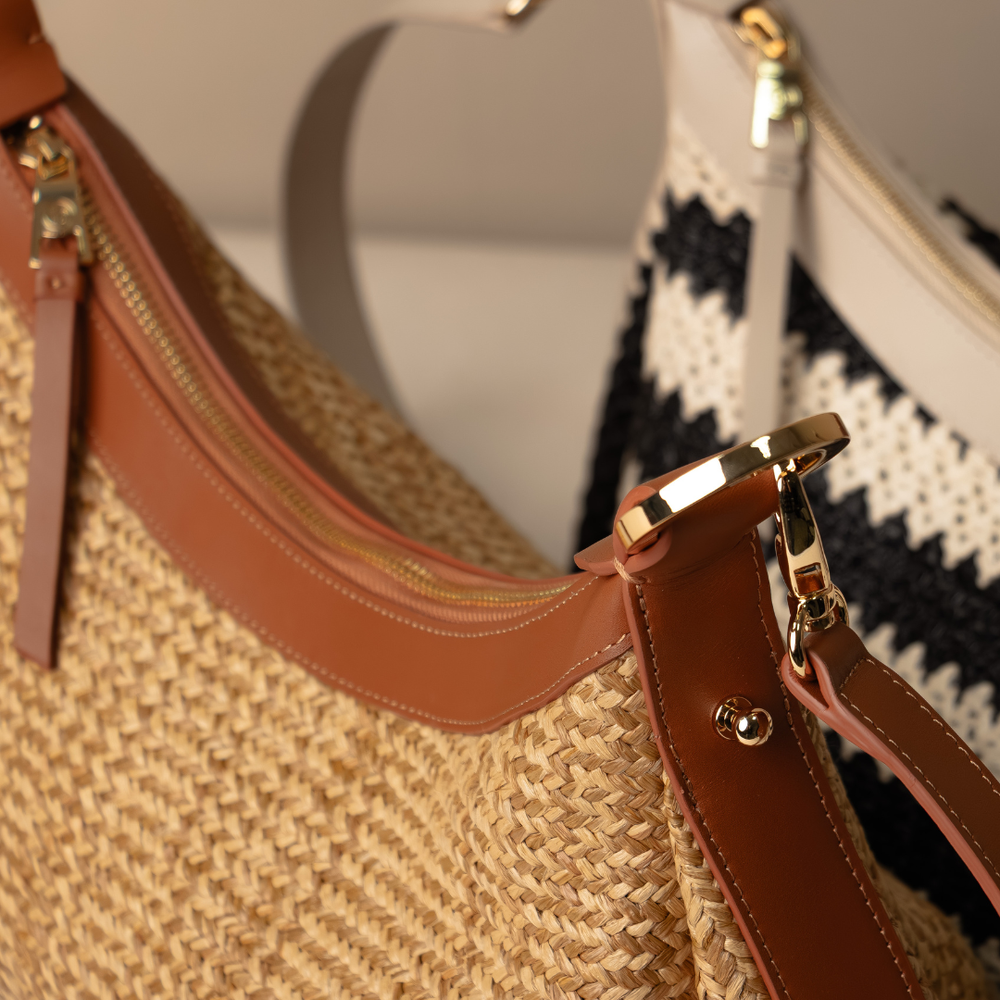 Close up Mini Mia 26 Raffia handcrafted with raffia and leather, with different designs and colors on a neutral background