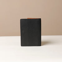 Back view of leather passport case Nirua on neutral background