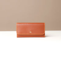 Three Elise Wallets in black, brown, and blue colors, displayed in an overlapped fashion on a light background.