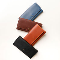 Three Elise Wallets in black, brown, and blue colors, displayed in an overlapped fashion on a light background.