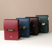 A collection of leather crossbody bags in various colors, aligned in a row, each with a clasp closure and the letter 'D' logo.