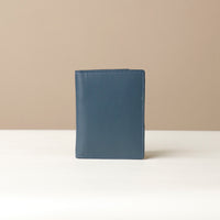 Blue Back view of leather passport case Nirua on neutral background